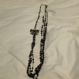 Long layered black and chrome silver bow necklace